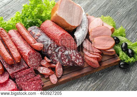 Assortment Of Delicious Deli Meats On Wooden Board