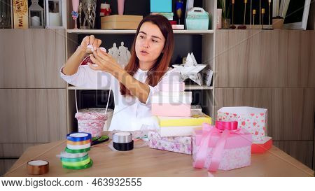 Gifts Wrapping. Attractive Woman, Designer Of Gifts And Decorations Shows Training Online, Records V