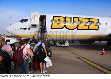 Agadir, Morocco - February 27, 2022: Passengers Board By Stairs Boeing 737 Max Of Ryanair Buzz Airli