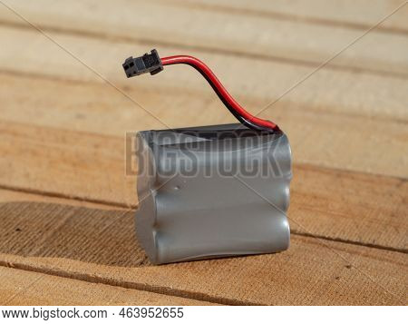 Battery For Radio-controlled Toys. 
Lithium-ion Battery For Radio-controlled Toys Close-up On A Wood