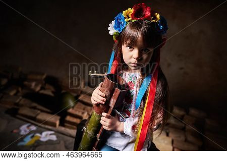 A Child Of War In A Ukrainian Shirt And A Wreath On His Head, Holding A Bazooka, A Grenade Launcher.
