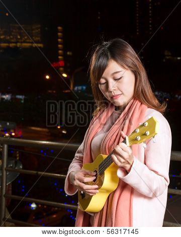 Pretty Asian Woman With Ukelele