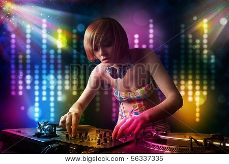 Pretty Dj girl playing songs in a disco with light show