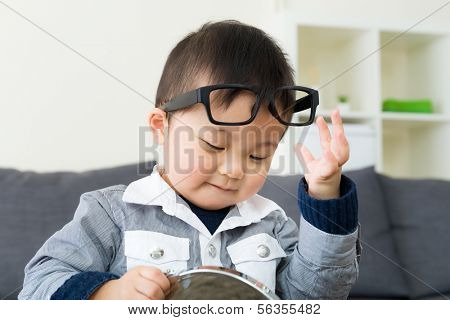 Asian boy wear glasses with mirror