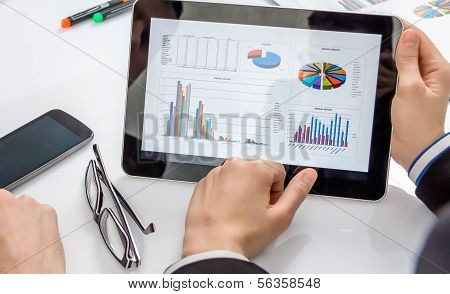 Business People Analyzing Documents In A Meeting