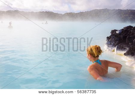 Beautiful Young Woman In Blue Lagoon Geothermal Spring , Iceland