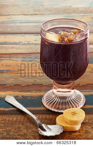 Acai In Glass With Banana On Wooden Table
