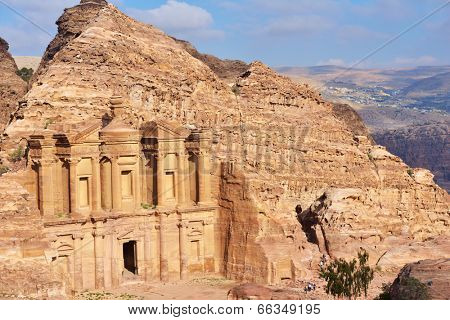PETRA, JORDAN - MARCH 15, 2014: Tourists near the Monastery, Petra's largest monument. Since 1985, Petra is listed as UNESCO World Heritage site