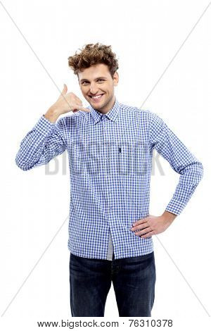 Young casual man showing call me gesture, Communicati on