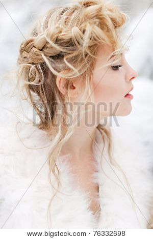 Portrait of beautiful woman in winter forest