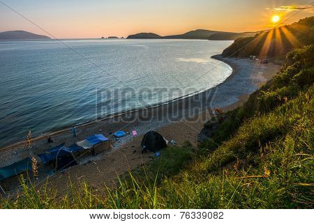 camping on the beach against sunset of russian isle Putyatin 