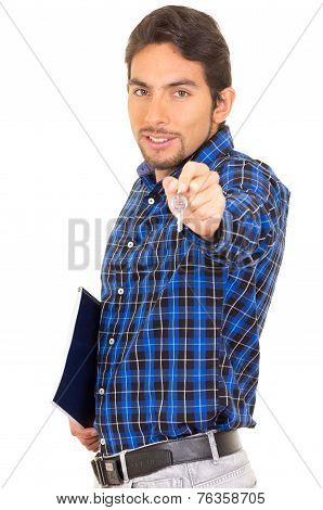 portrait of handsome hispanic male real estate agent holding a key