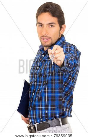 portrait of handsome hispanic male real estate agent holding a key