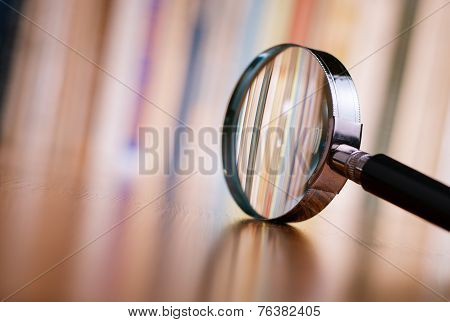 Close Up Magnifying Glass Leaning On Wooden Table