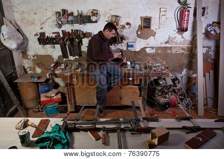 Carpenter Carving An Assembly Hole