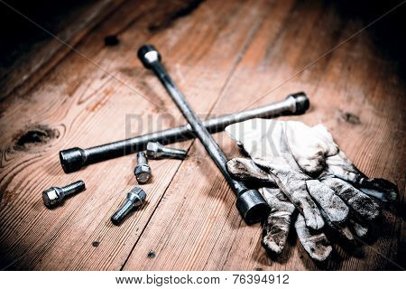 Old Used Wrench With Screw And Dirty Gloves