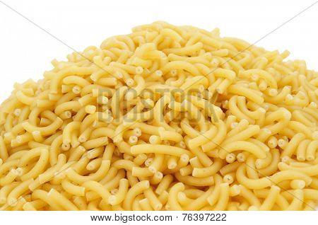 a pile of uncooked macaroni on a white background