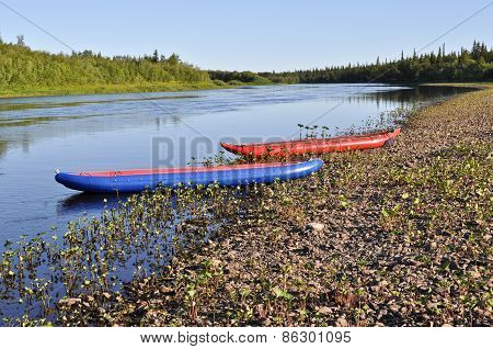 Inflatable Kayaks On  Shore Of The River.
