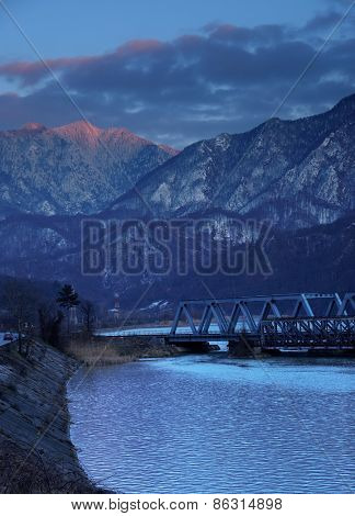 Railroad Bridge through the Carpathian Mountains, passing by the Olt Valley, Romania - sunset blue hour light
