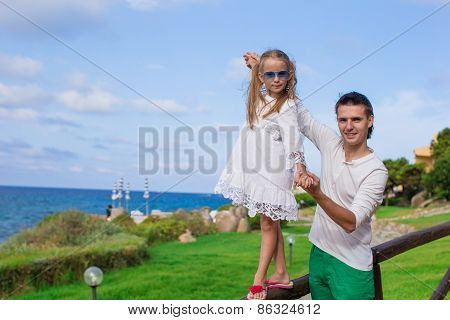 Adorable little girl and happy dad outdoor