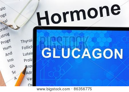 Papers with hormones list and tablet  with word glucagon.