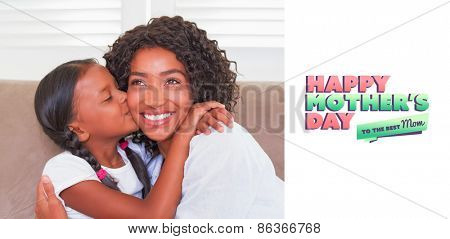 mothers day greeting against pretty mother sitting on the couch with her daughter kissing her cheek