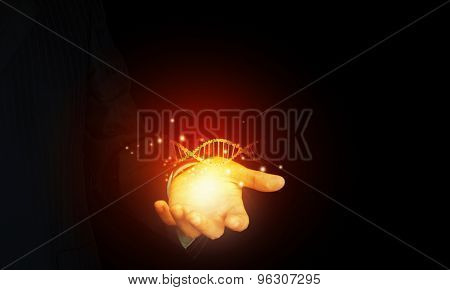 Close up of man holding DNA molecule in palm