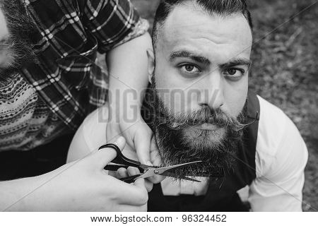 two bearded men shave