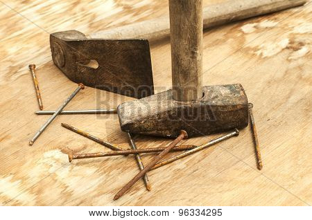 Old hammer, adze and rusty nails