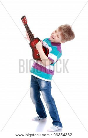 Little boy playing guitar