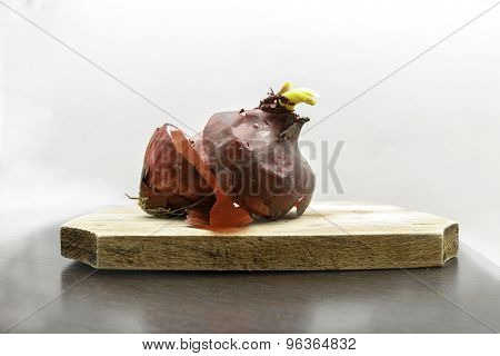 Red Onions On A Wooden Cutboard