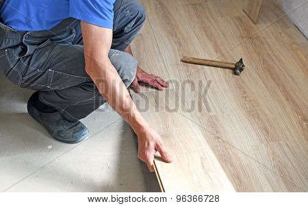 Male Carpenter Puts The Laminate