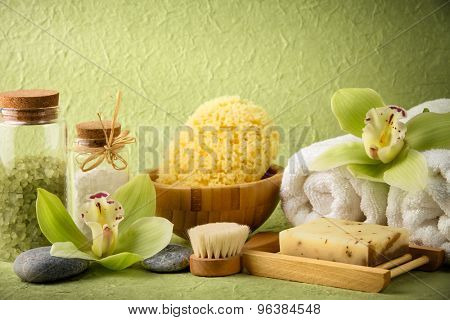 Spa still life with salt,towel,sponge,handmade soap and blooming orchid
