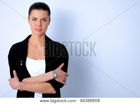 A young woman standing, isolated on graybackground