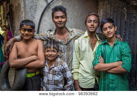 MUMBAI, INDIA - 12 JANUARY 2015: Five Indian boys from Dharavi slum stand in street. Dharavi is one of the largest slums in the world.