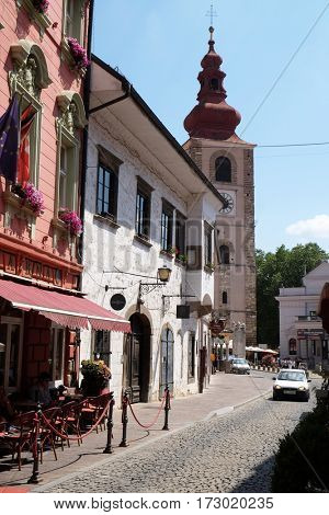 PTUJ, SLOVENIA - JULY 02: Medieval street and Saint George church in Ptuj, town on the Drava River banks, Lower Styria Region, Slovenia on July 02, 2016.