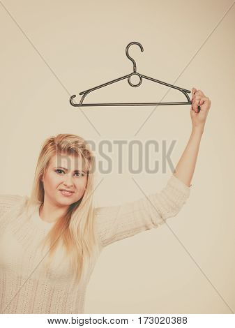 Blonde Woman Holding Clothes Hanger