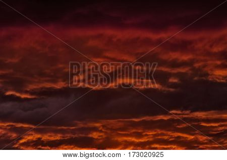 the storm sky with various shades of red color with dark clouds