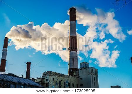 the thick smoke belching from factory chimneys