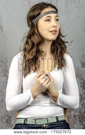 Portrait of a young romantic girl with curly hair and a white blouse