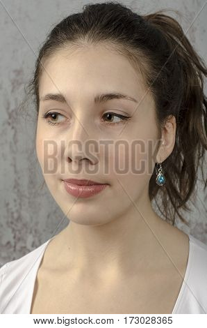 Portrait of a young romantic girl with curly hair and a white blouse