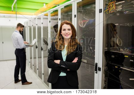 Portrait of technician standing with arms crossed in a server room