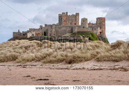 Bamburgh Castle is in Northumberland on the North East coast of England it is perched on a basalt outcrop overlooking the North Sea. Close to The Farne Islands & Holy Island: Bamburgh Northumberland England UK March 15 2016.