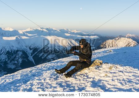 Tourist Pours Hot Tea From A Thermos Into A Cup.