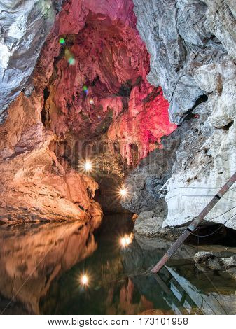 A still lake inside a cave artificially enlightened