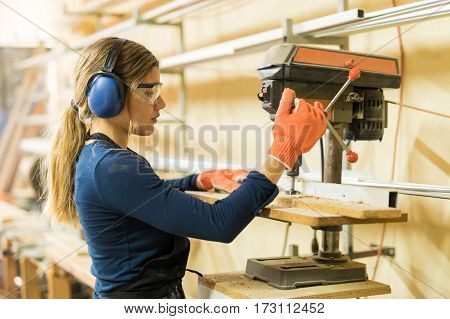 Woman Using A Drill Press For Work