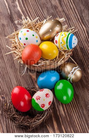 Colorful easter edds on a brown wooden table