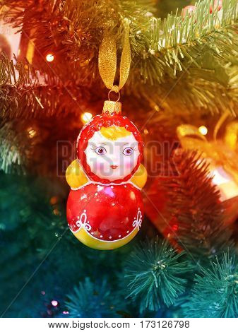 Beautiful Russian toy matryoshka photographed closeup on the Christmas tree