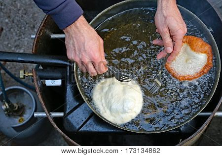 Cook Hands Two Pancakes In A Frying Pan With Hot Oil