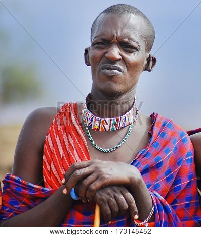 AMBOSELI, KENYA  10 13 11: Portrait of young Maasai man in Masai Mara, Kenya. Maasai (Masai) are a Nilotic ethnic group of semi-nomadic people located in Kenya and northern Tanzania